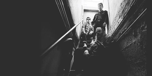 Impotentie sit in a stairwell, from the cover of their album Zonder Titel Deze Keer