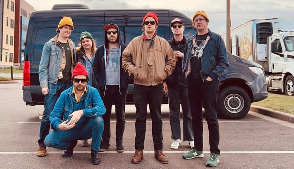 Ryan Davis & the Roadhouse Band outside their van somewhere in Wisconsin